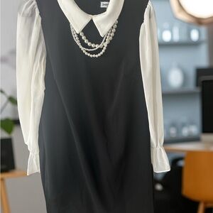 Elegant Black and White Dress with Pearl Necklace